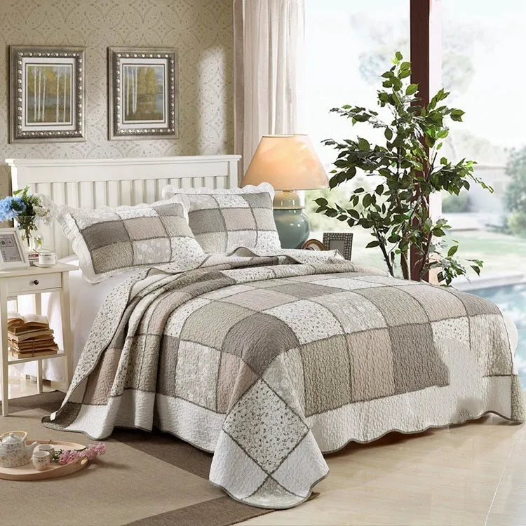 Washed pure cotton quilted bedspread and pillowcase three-piece set in a beige colour pattern on a bed.
