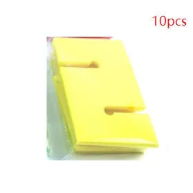 Outdoor team building equipment set with coloured plastic blocks, pull ropes, and a metal hook frame on grass.