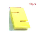 Outdoor team building equipment set with coloured plastic blocks, pull ropes, and a metal hook frame on grass.