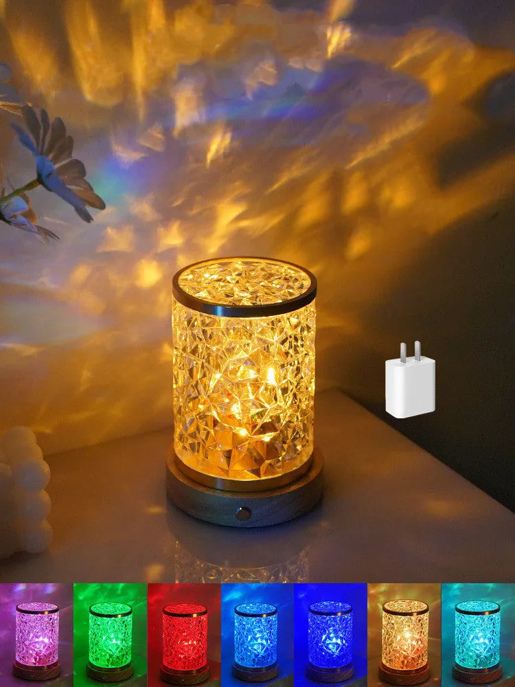 Rotating water ripple effect night light with clear acrylic body on a solid wood base.