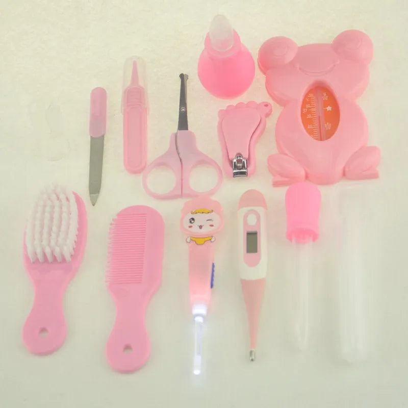 13-piece newborn baby care kit with pink grooming bag containing thermometer, scissors, brush, comb, nail clipper, and medicine tools