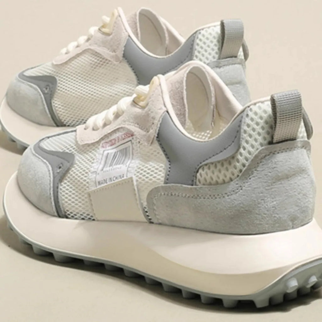 Women's grey and pink low-top retro sneakers with a round toe and flat rubber sole.