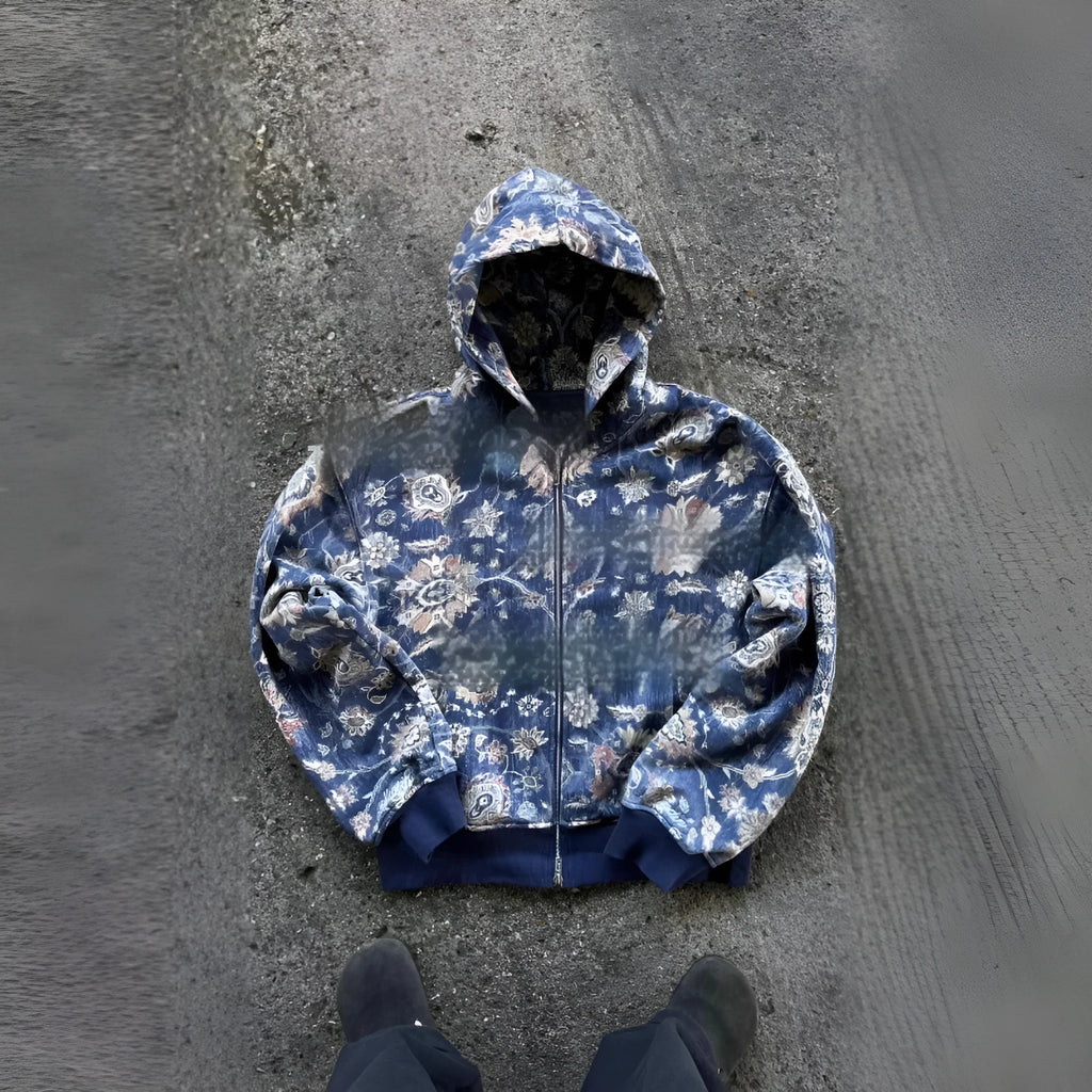 A blue loose-fitting men's hooded zip coat with long sleeves, shown on a hanger.