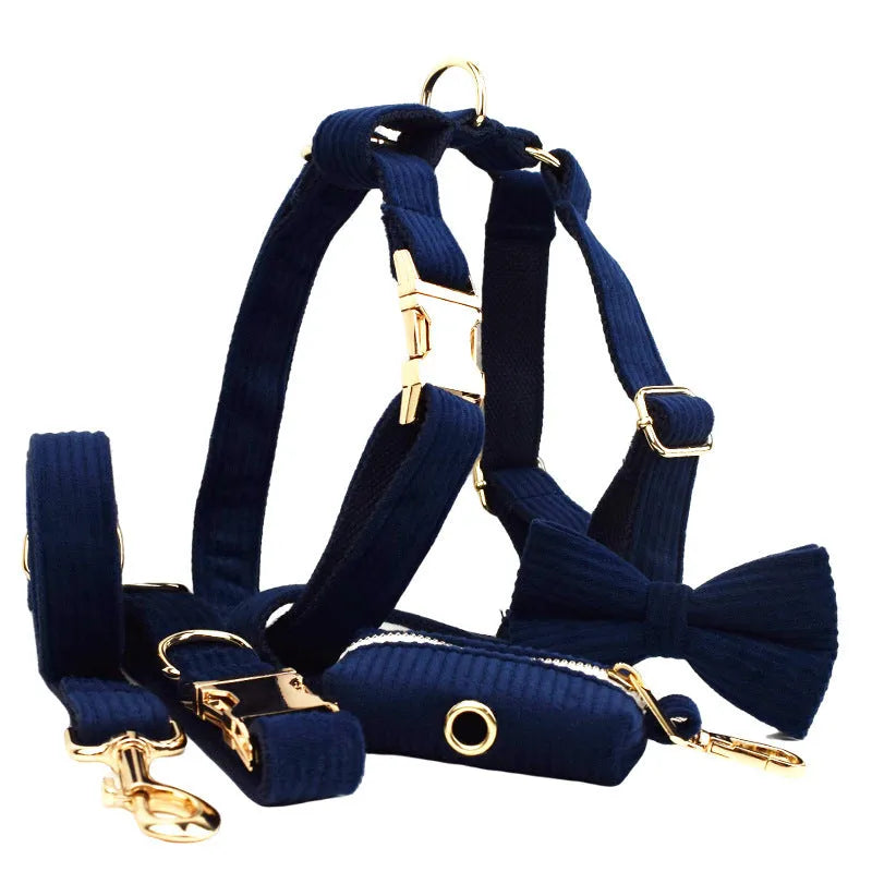 Navy blue corduroy dog collar leash set with bow, vest, and poop bag on white background