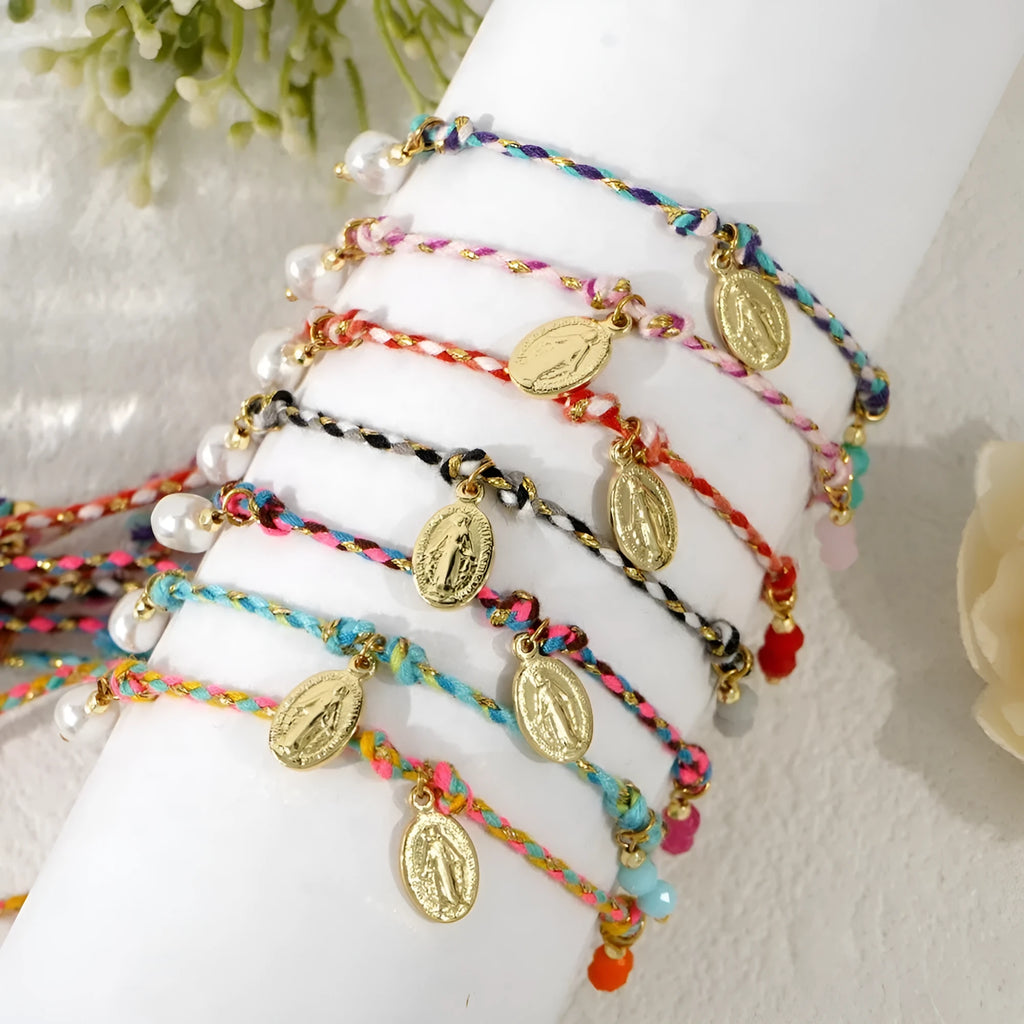 Close-up of a hand-woven colourful braided rope bracelet for women with an integrated fabric strap tag.