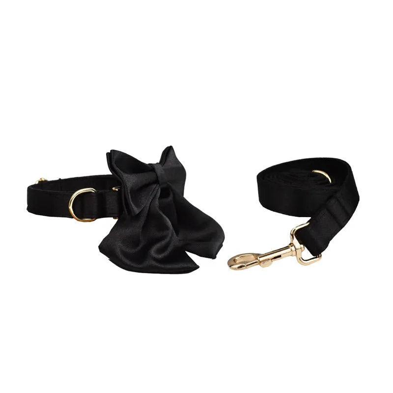 A complete cloth dog accessory set showing a collar, leash, chest strap, vest, and decorative bow in matching colours.