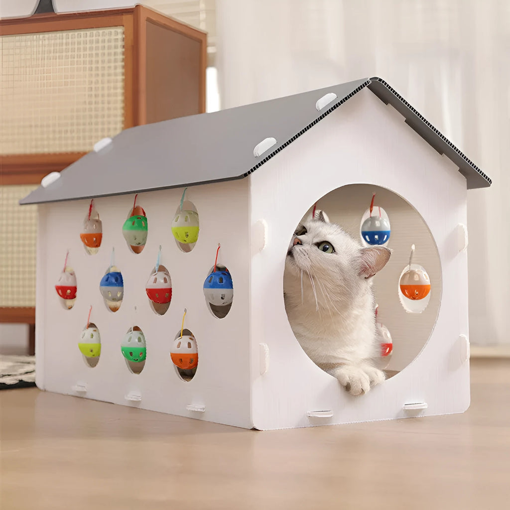 Plastic integrated cat scratch board with attached nest bed and tunnel containing a bell ball toy.