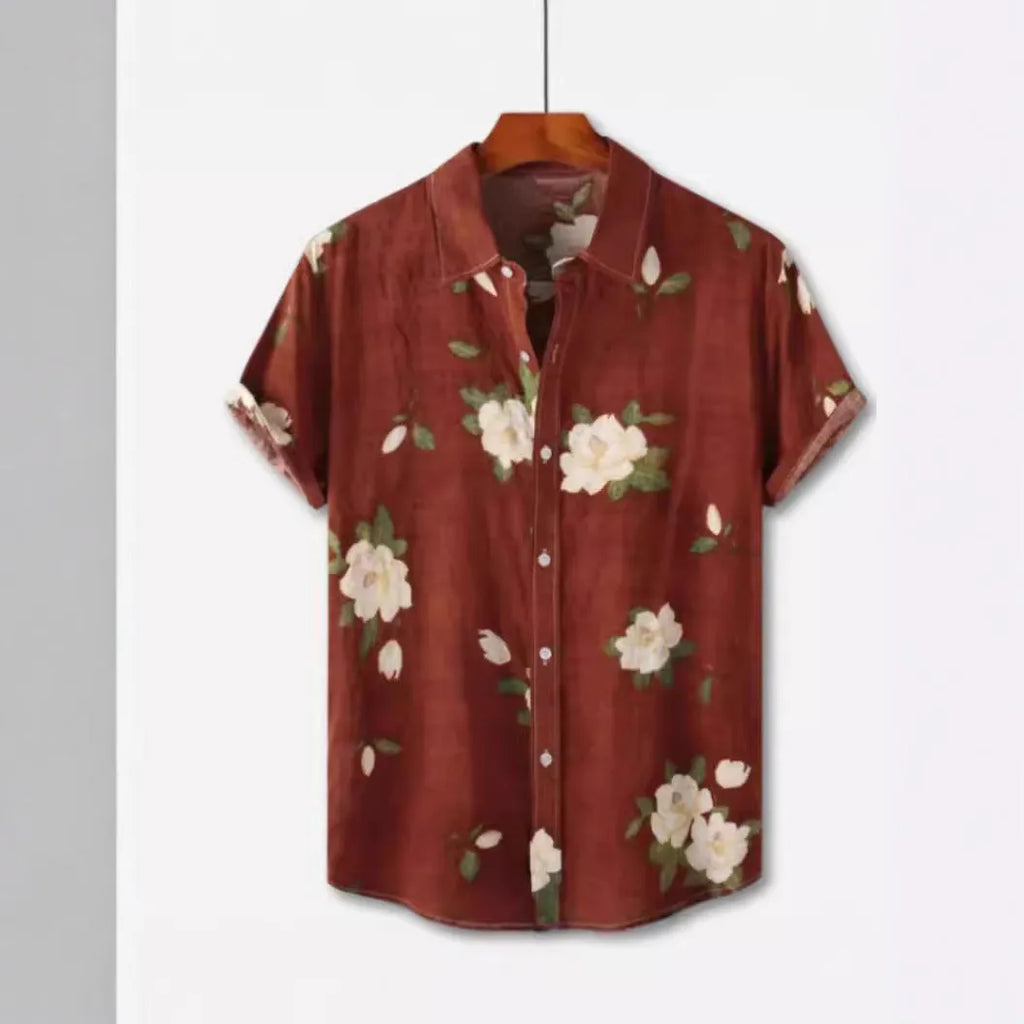 Man wearing a short sleeve Hawaiian shirt with a colourful floral print pattern.
