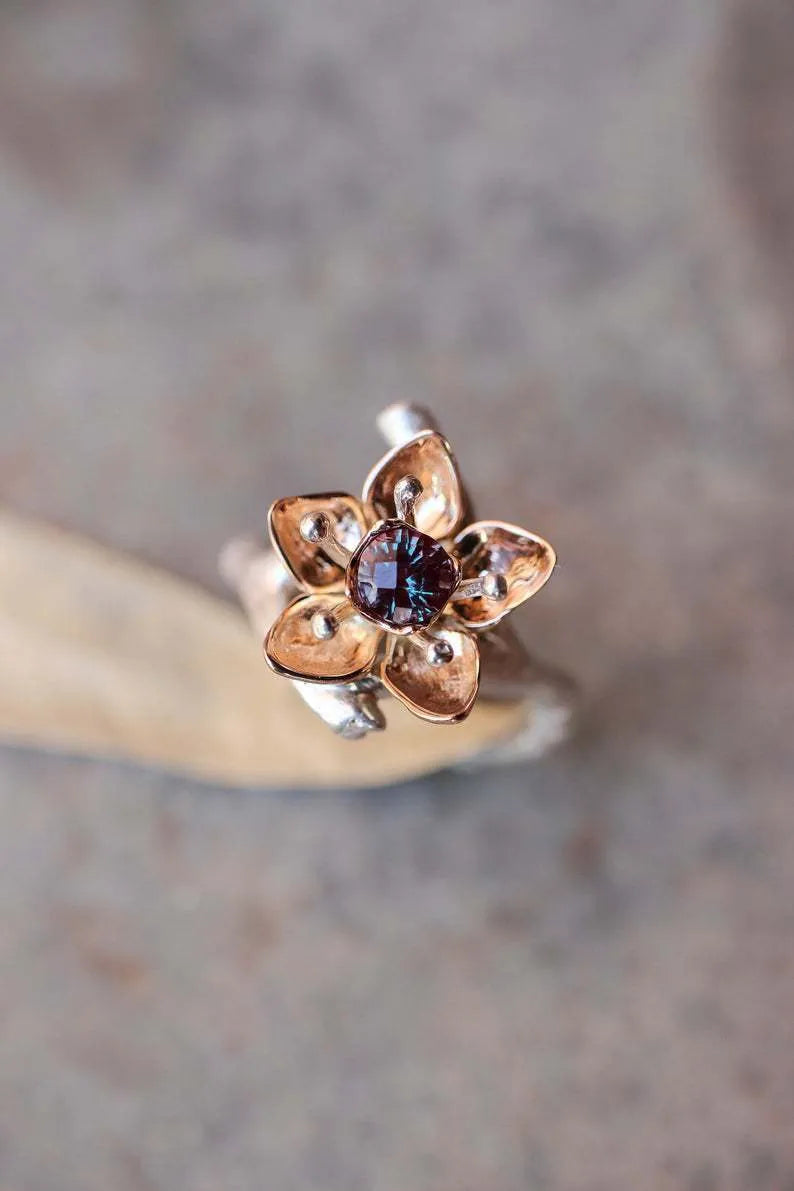 Silver two-tone women's alloy ring with geometric floral pattern, shown on a model finger.