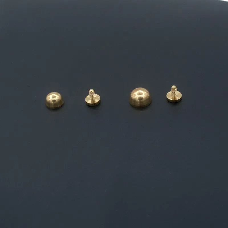 Solid brass decorative buckle for clothing in round and geometric foot nail designs.