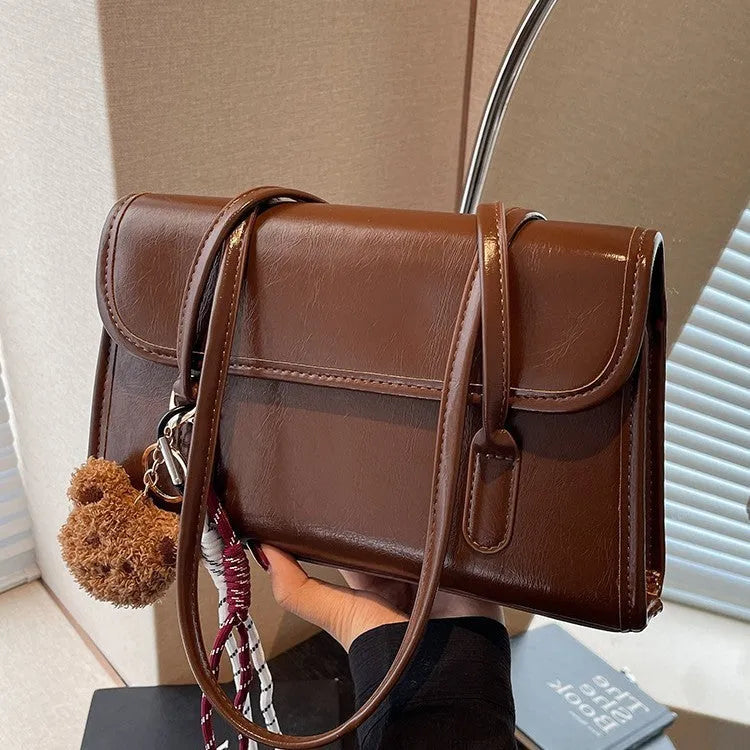 Brown women's PU Maillard handbag with pendant detail, horizontal square shape, and double shoulder straps