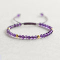 Women's freshwater pearl and crystal bracelet with geometric design on a simple braided or elastic rope band.