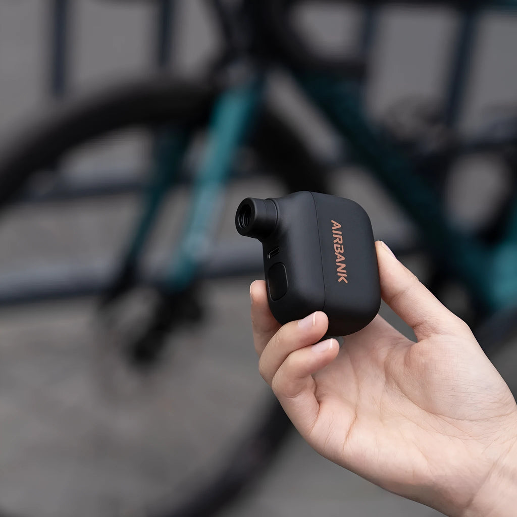 Black AS100 electric bicycle tyre inflator with USB cable and waterproof bag