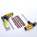 Vacuum tyre repair tool kit with probe, pin, glue, and rubber strips for puncture repair.