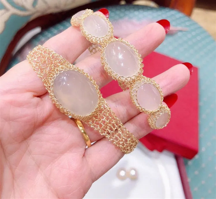 14k gold wire natural white chalcedony bracelet with adjustment chain on neutral background