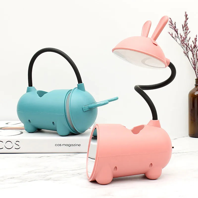 Cartoon-themed USB table lamp with pen container in green, dark blue, or pink plastic