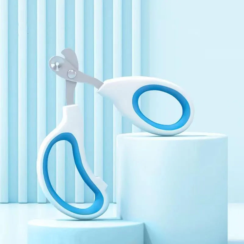 Blue pet nail clippers with a circular cutting hole and cushioned non-slip handle.