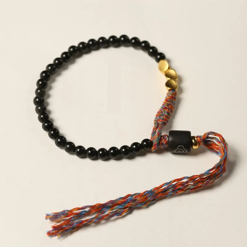 Hand-woven obsidian carrying strap bracelet showing textured surface and 4mm width detail