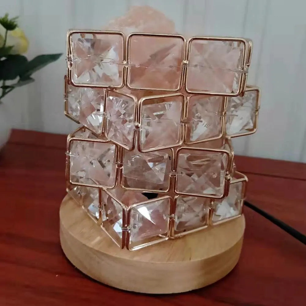 Himalayan crystal salt lamp with dimmer switch on wooden base emitting warm amber glow