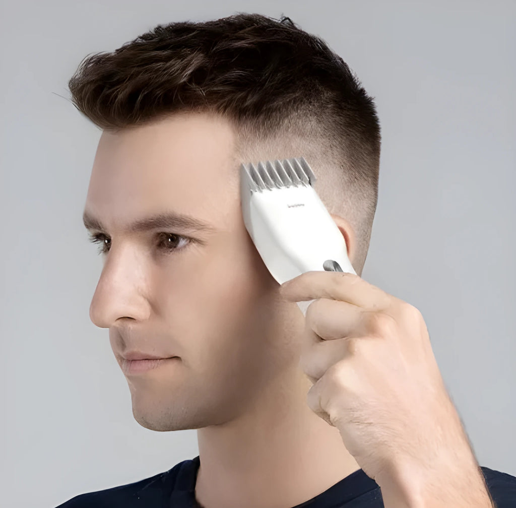 Black and white cordless Boost hair clipper with adjustable slider comb and nano ceramic cutter head.