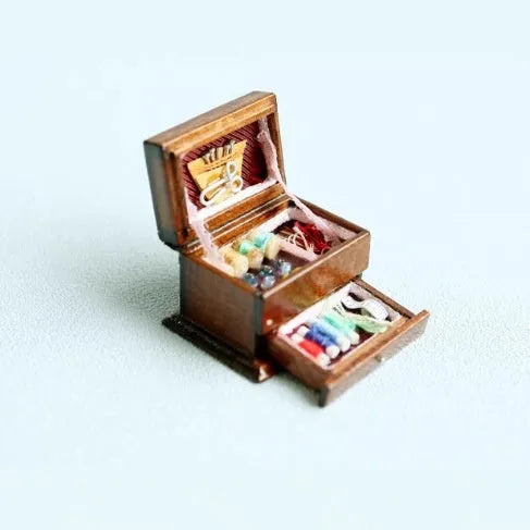 Miniature wooden sewing machine ornament with European-style design on display