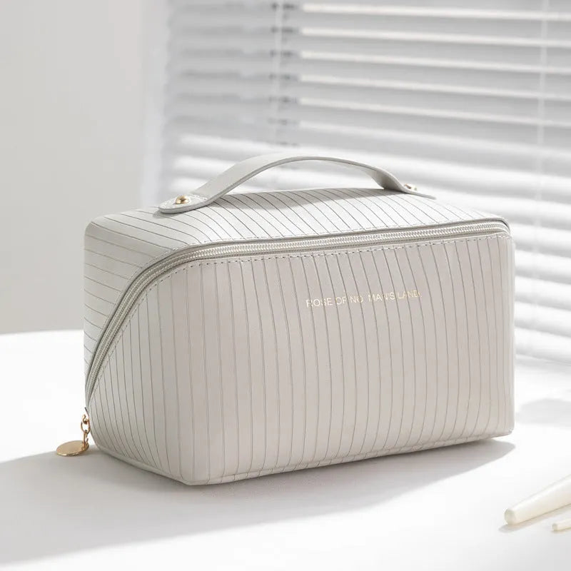Vertical pattern pillow makeup bag with cubic shape measuring 22.5cm in PU material