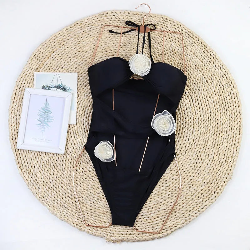 Women's black and blue striped one-piece swimsuit with a 3D flower design