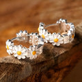 White daisy flower ring earrings with platinum gem inlay on a copper base.