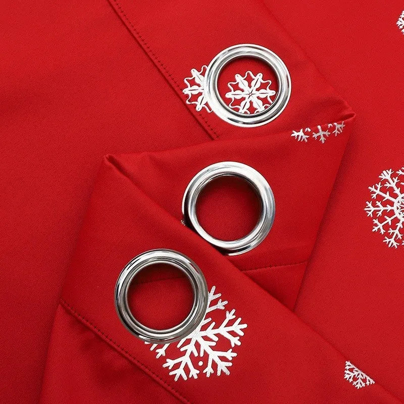 Red snowflake pattern shade cloth curtain with lace loop detailing hung on window