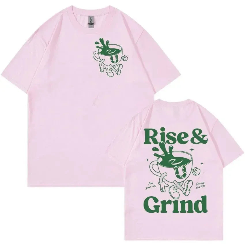 Man wearing a black loose-fit t-shirt with a green 'Rise And Grind' coffee cartoon graphic on the front.