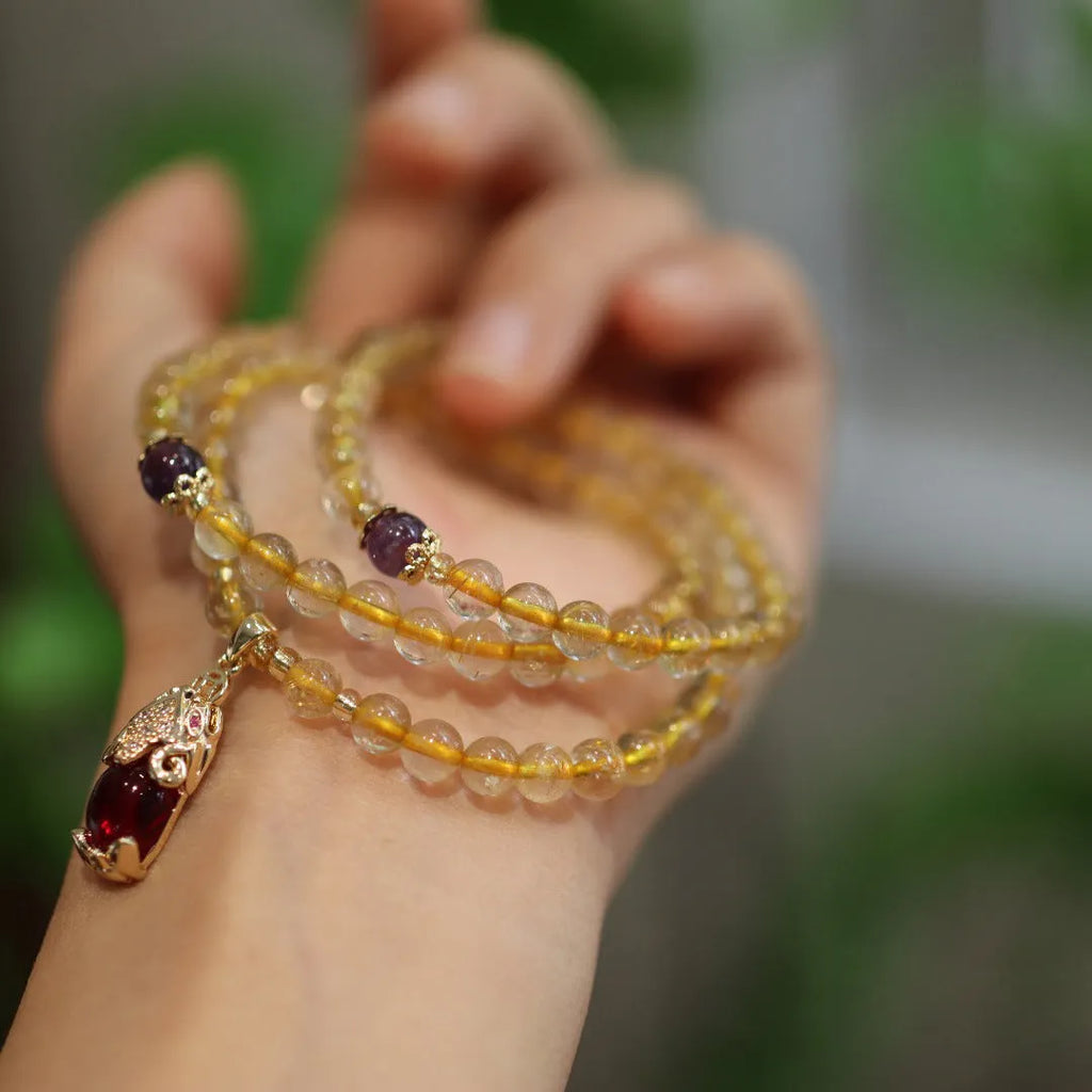 Natural gold rutilated quartz bracelet with hanging chopsticks design