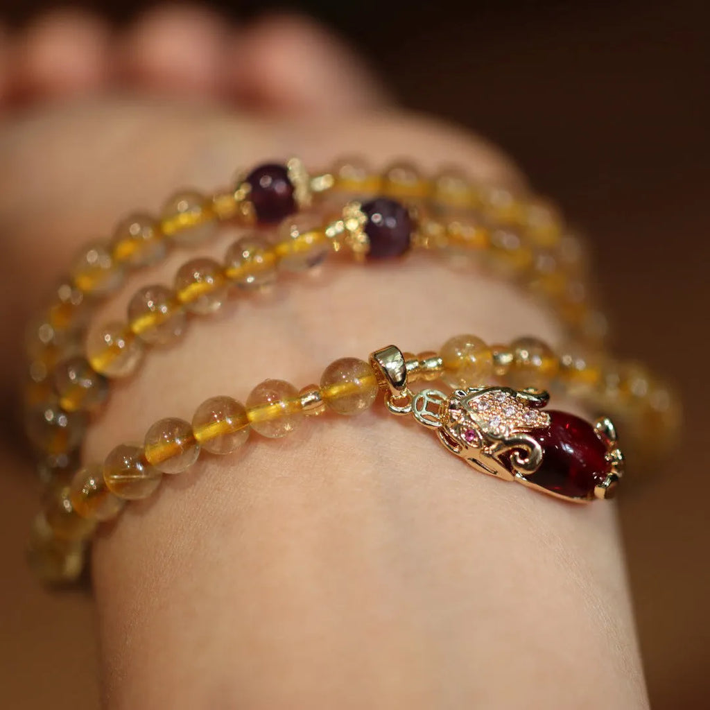 Natural gold rutilated quartz bracelet with hanging chopsticks design