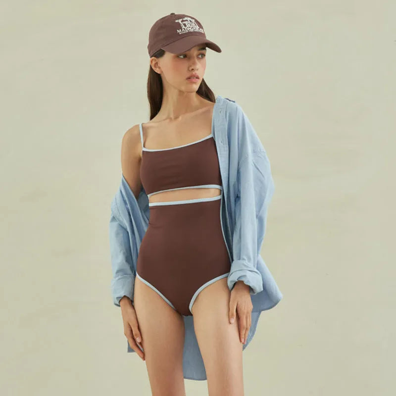 Brown women's triangle one-piece swimsuit with a pattern, shown on a hanger