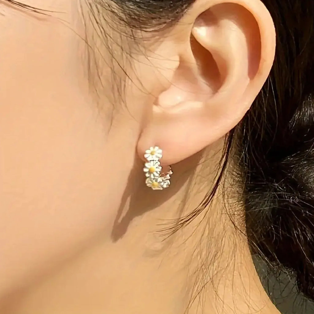 White daisy flower ring earrings with platinum gem inlay on a copper base.