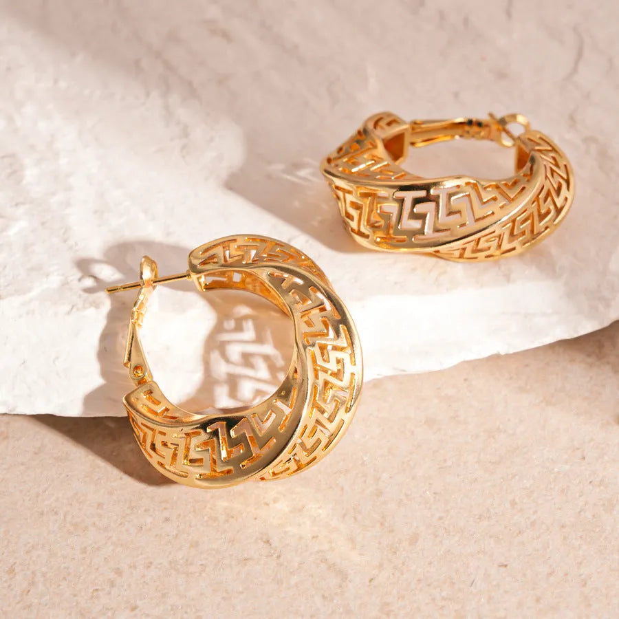 Women's geometric hollow stud earrings with twisted round design in silver or gold electroplated finish