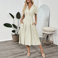 Light green women's shirt dress with lapel collar, waist tie, and hidden skirt pockets on a hanger.
