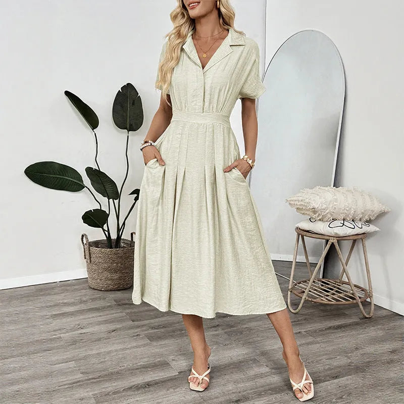 Light green women's shirt dress with lapel collar, waist tie, and hidden skirt pockets on a hanger.