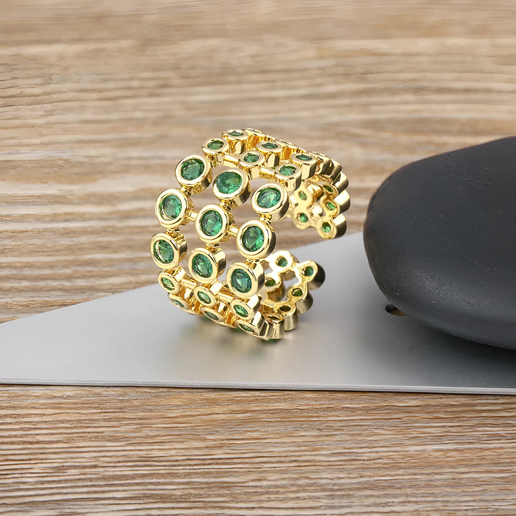 Copper ring with 18K gold colour plating and large green zircon stones on a wide band.