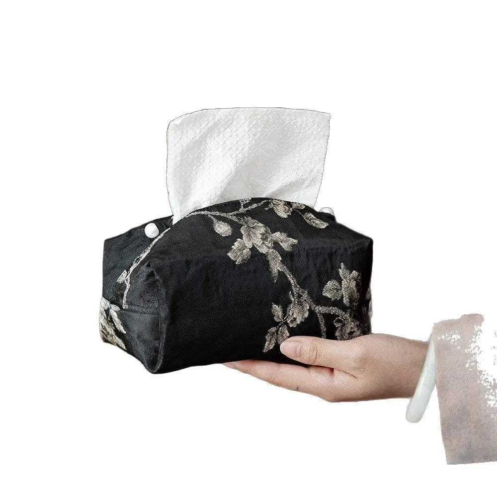 White Chinese brocade tissue box with embroidered plum blossoms, shown with and without a pearl buckle.