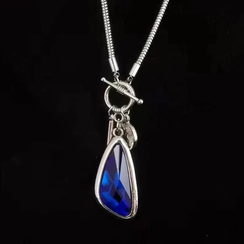 Long geometric plaid pendant necklace on a snake bones chain in alloy metal.