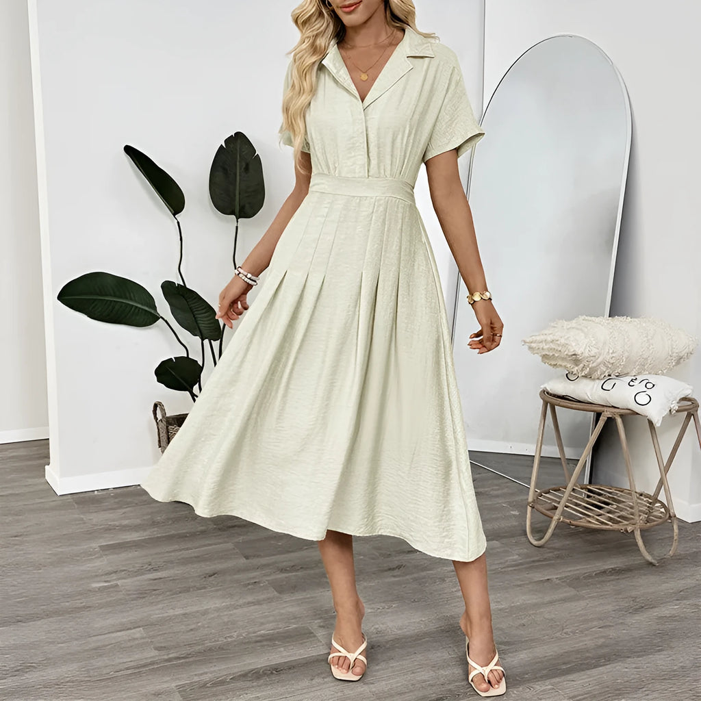 Light green women's shirt dress with lapel collar, waist tie, and hidden skirt pockets on a hanger.
