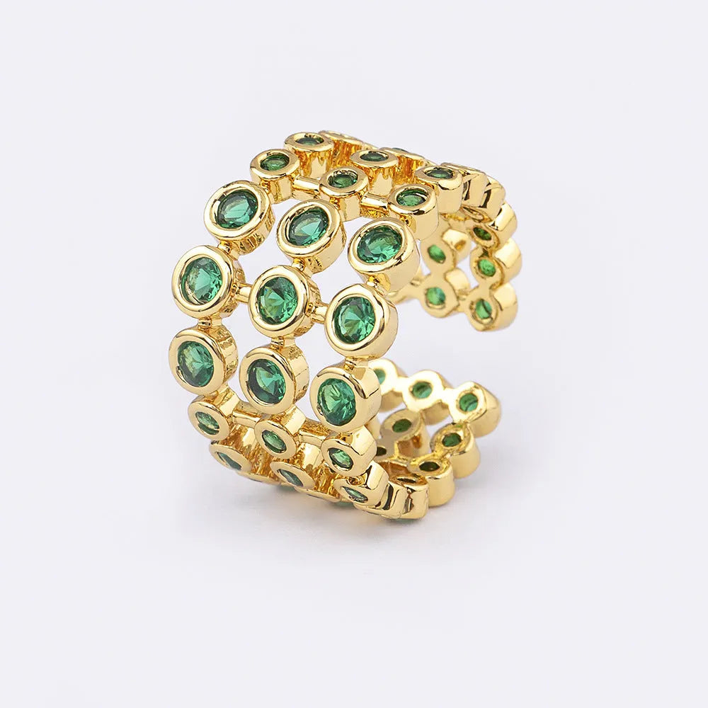 Copper ring with 18K gold colour plating and large green zircon stones on a wide band.