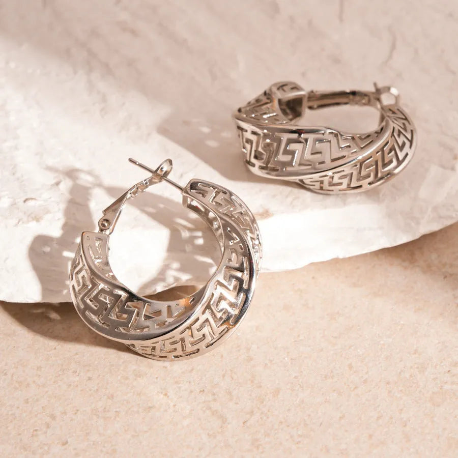 Women's geometric hollow stud earrings with twisted round design in silver or gold electroplated finish