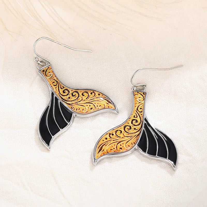 Women's white gold fishtail earrings with whale design elements in retro style