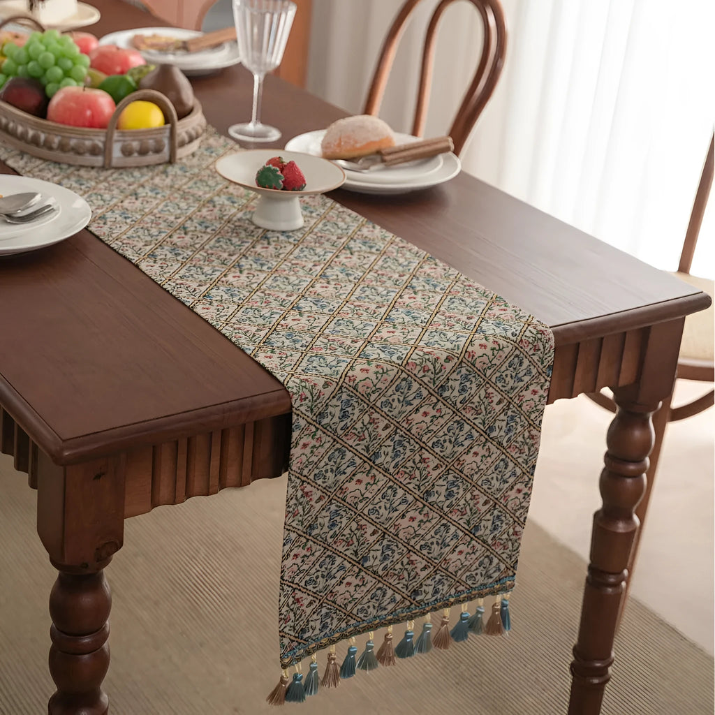 Dark blue Nordic jacquard stripe table runner with bouquet pattern and tassel fringe on a wooden table
