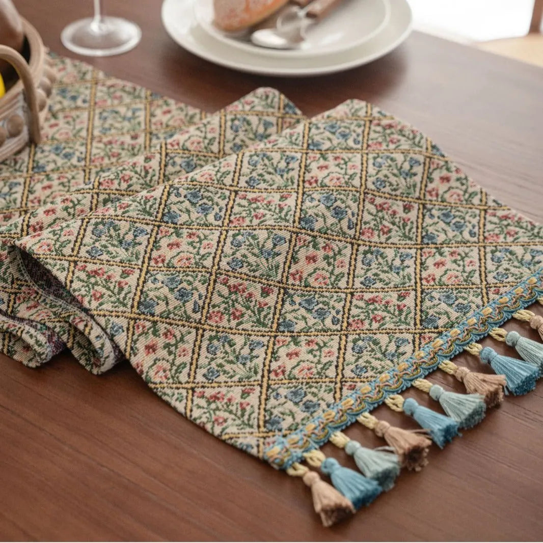 Dark blue Nordic jacquard stripe table runner with bouquet pattern and tassel fringe on a wooden table
