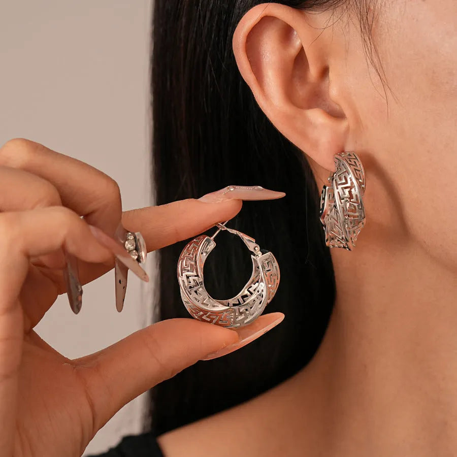 Women's geometric hollow stud earrings with twisted round design in silver or gold electroplated finish