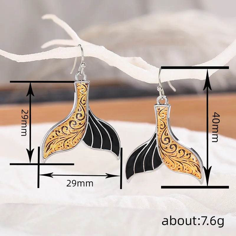Women's white gold fishtail earrings with whale design elements in retro style