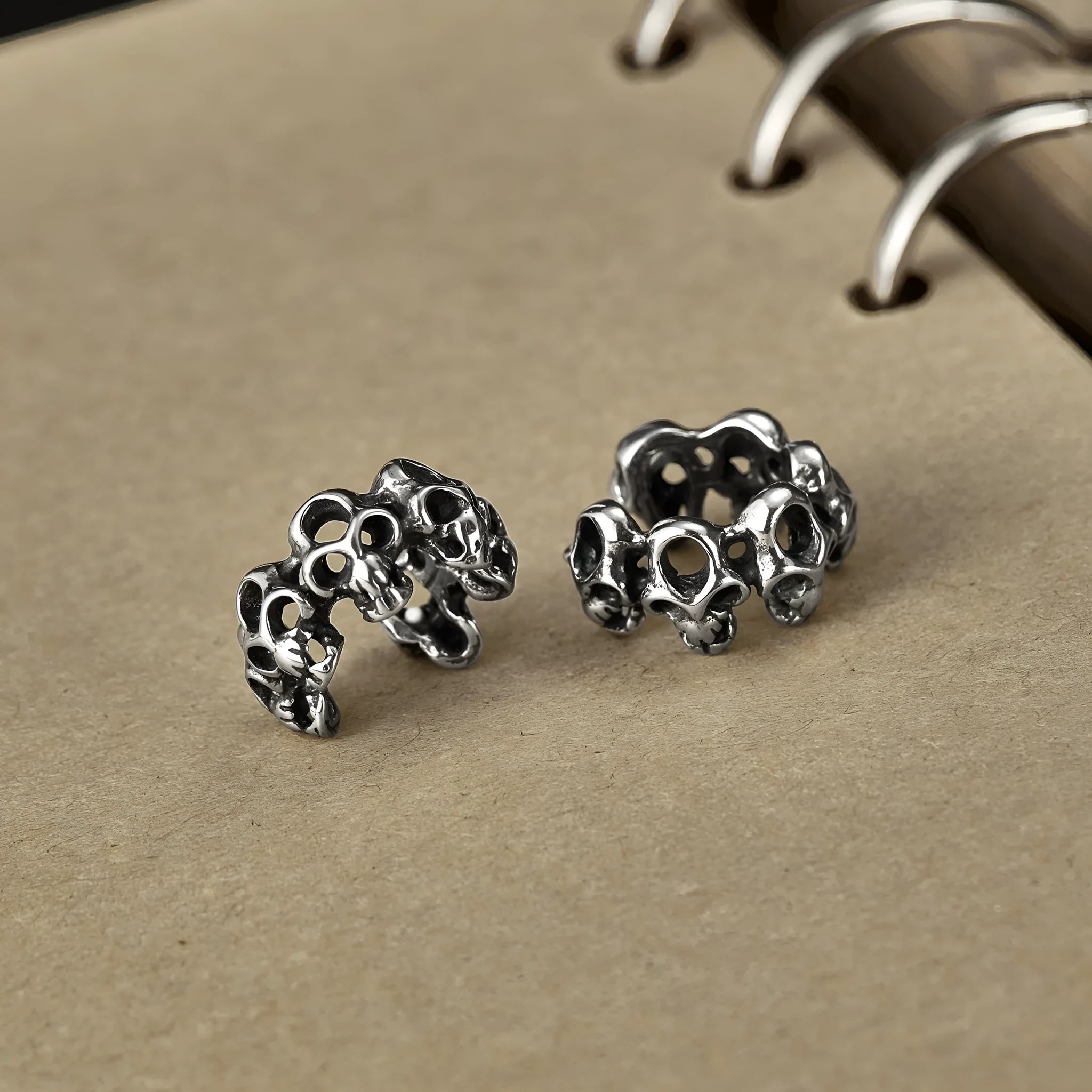 Stainless steel hollow skull earrings with geometric design and ear clips
