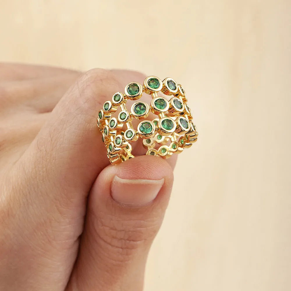 Copper ring with 18K gold colour plating and large green zircon stones on a wide band.
